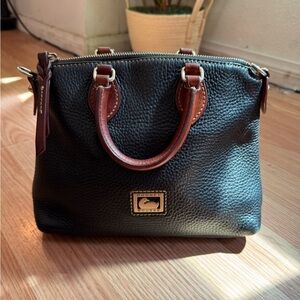 Dooney & Bourke Black Pebbled Leather hand bag with Brown Trim and Gold Hardware